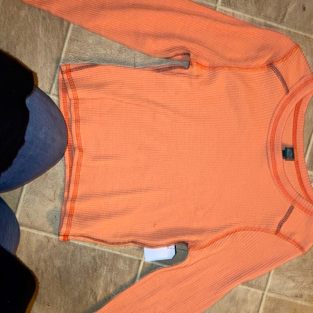 It is a kid shirt long sleeve and comes in multiple sizes